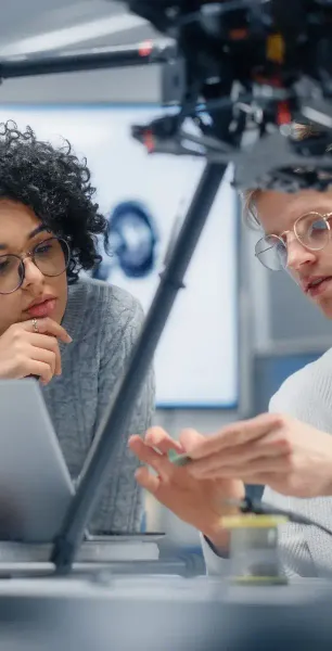 Two engineers working together on a hardware prototype